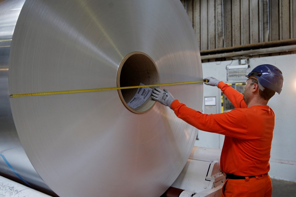 A worker mesures the diameter of a coil of aluminium at the Neuf-Brisach Constellium aluminium products company's production unit in Biesheim